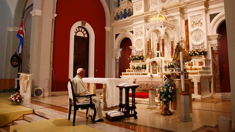 Pope Francis prays inside the sanctuary of the Virgin of Charity in El Cobre, Cuba, September 21, 2015.