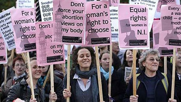 Pro-choice campaigners started the Twitter hashtag to destigmatize the procedure. campaigners protest in London.