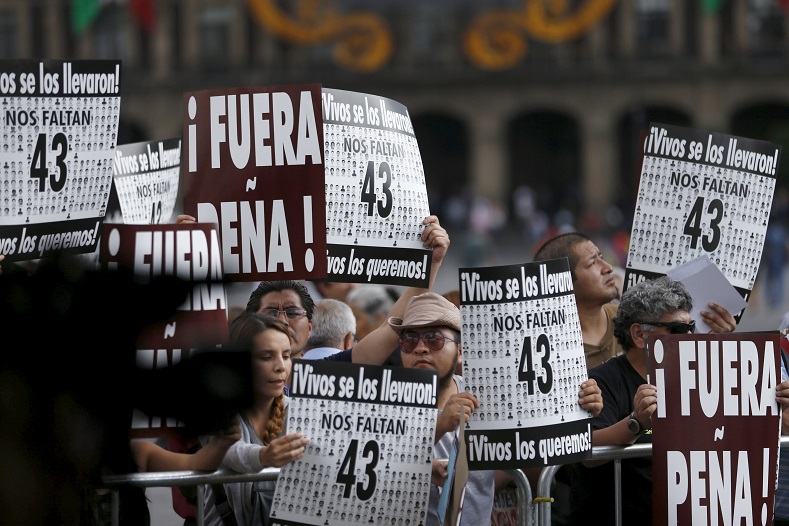 Protesters demanded the resignation of President Enrique Peña Nieto due to his government's inability to bring justice to Ayotzinapa.