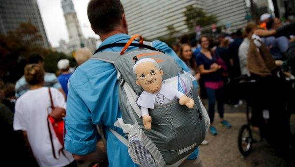 A man carries a toy version of Pope Francis, Philadelphia, Sept. 27, 2015.
