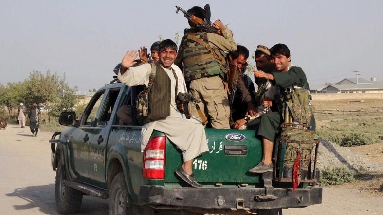 Afghan police sit at the back of a truck near a frontline during a battle with the Taliban in Kunduz city, northern Afghanistan, September 29, 2015.