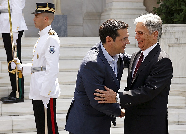Greek Prime Minister Alexis Tsipras (L) greets Austrian Chancellor Werner Fraymann.
