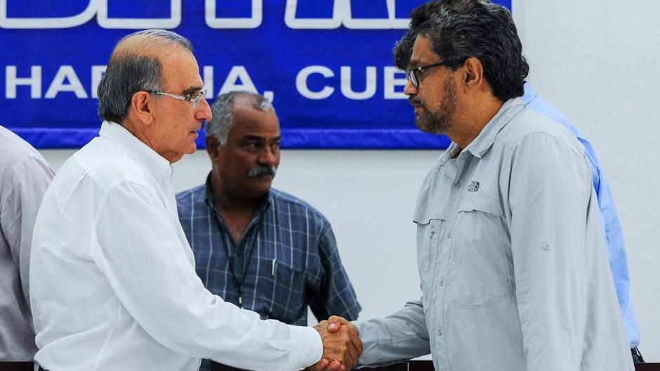The FARC commander Ivan Marquez (R) and the head of the Colombian delegation, Humberto de la Calle (L), shake hands during talks in Havana, Cuba.