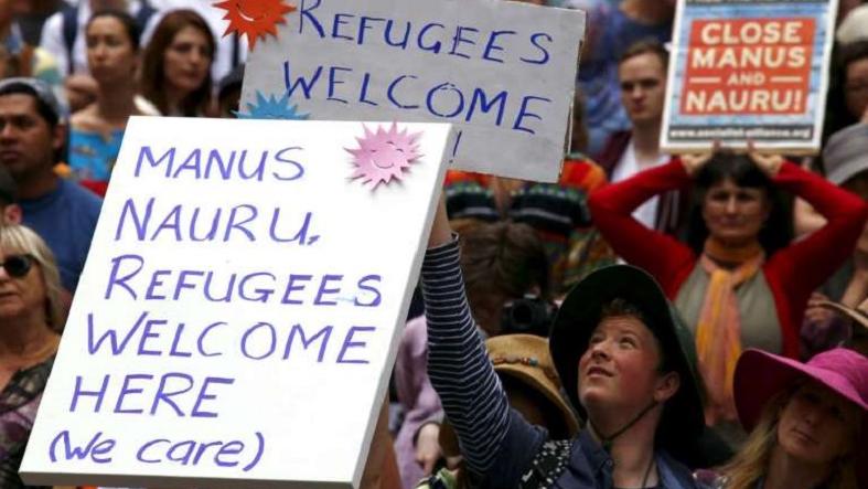 Demonstrators hold placards during a rally in support of refugees that was part of a national campaign in central Sydney, Australia, on Oct 11, 2015.