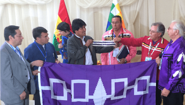 Bolivian President Evo Morales holds a replica of Tow Row Wampum with Mohawk Chief Howard Thompson and Kenneth Deer, Mohawk.