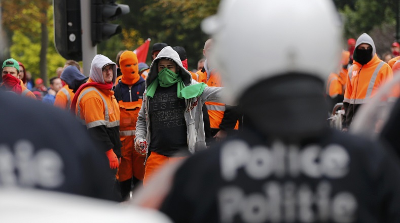 Demonstrators confront riot police in central Brussels during a protest over the government's reforms on Oct. 7, 2015, eight days before the TTIP protest.