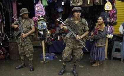 Soldiers stand guard at a market in Coban, in the state of Alta Verapaz Jan. 12, 2011