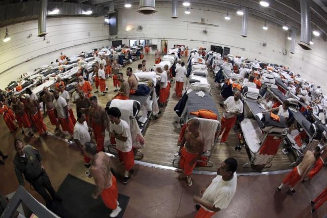 Inmates walk around a gymnasium where they are housed due to overcrowding at the California Institution for Men state prison in Chino, California, June 3, 2011.