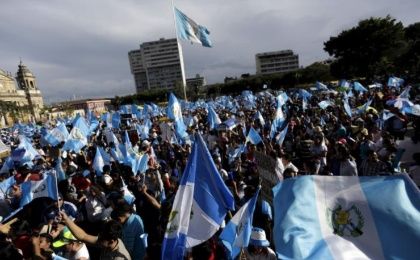 Protesters wave Guatemalan national flags during a demonstration to demand the resignation of now former President Otto Perez Molina in downtown Guatemala City, Aug. 29, 2015.