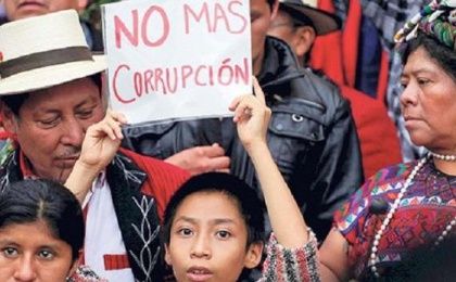 Indigenous protesters hold a sign saying “no more corruption” in Guatemala City, Aug. 2015. 