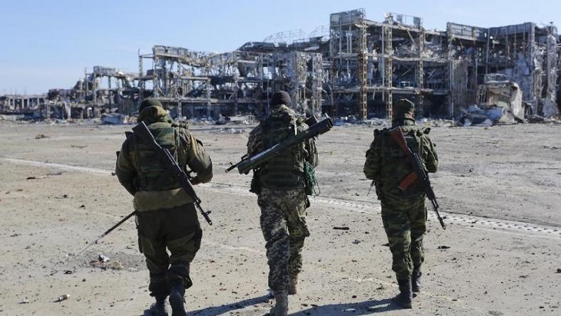 Pro-Russian rebels walk toward the destroyed Donetsk international airport on October 13, 2015.