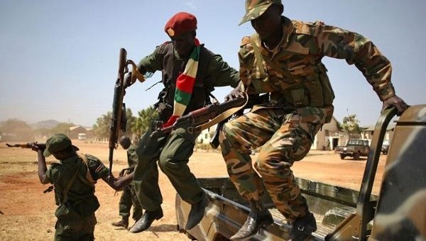 South Sudan soldiers jump from an army vehicle in Juba. 