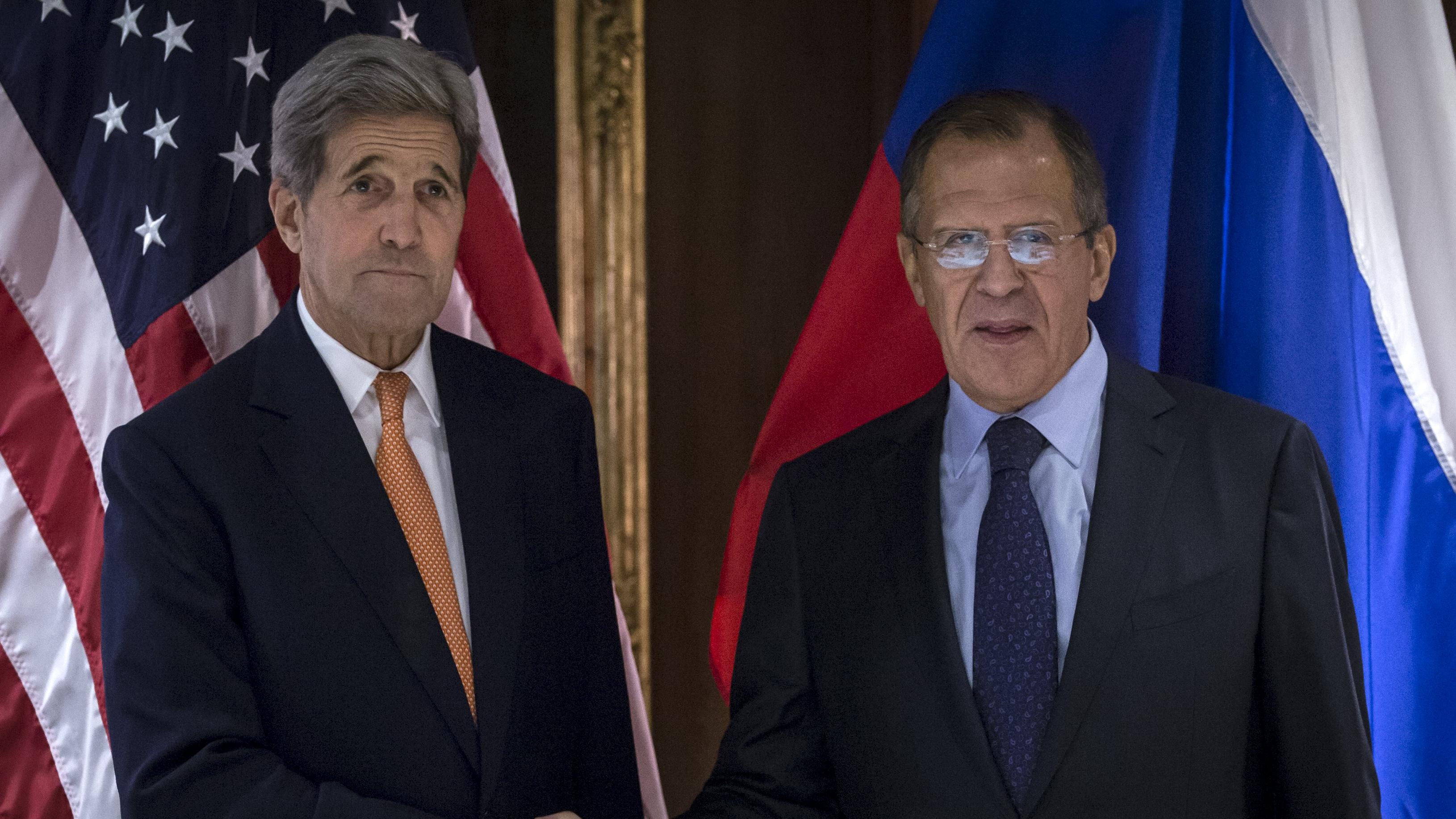 U.S. Secretary of State John Kerry (L) and Russian Foreign Minister Sergey Lavrov shake hands during a photo opportunity in Vienna, Oct. 23, 2015.