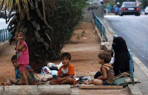Homeless refugees from Syria rest by the side of a road in the capital Beirut.