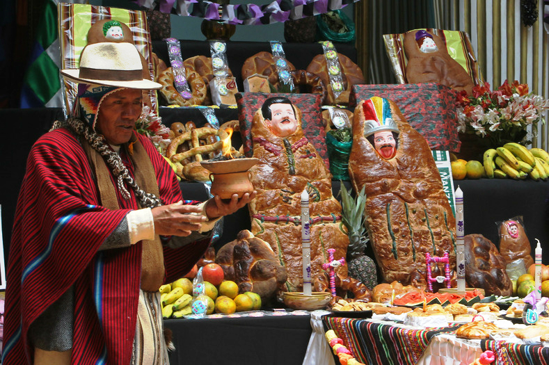 Bolivia: An Aymara shaman performs a Day of the Dead ritual to honor the food and T'antawawas.