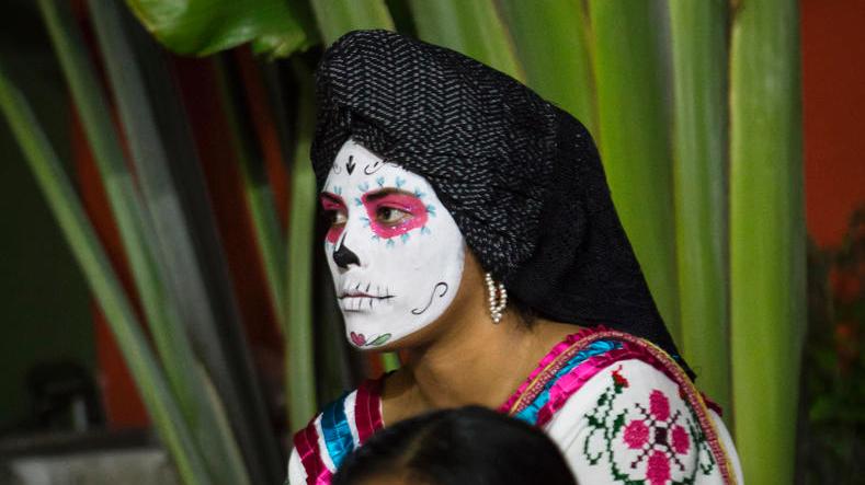  A woman from Oaxaca prepares for a parade in celebration of Day of the Dead.