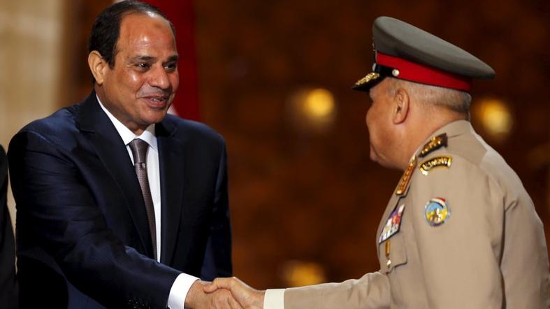 Egypt's President Abdel-Fattah el-Sissi shakes hands with Egypt's Defense Minister Sedki Sobhi.