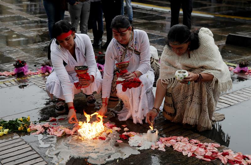Women light candles to commemorate the 30th anniversary of the siege of the Palace of Justice in Bogota, Colombia.