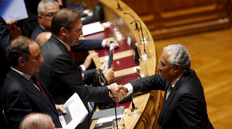 Portugal's Prime Minister Pedro Passos (L) shakes hands with Socialist Party leader Antonio Costa at a debate at the parliament in Lisbon, Portugal Nov. 10, 2015.