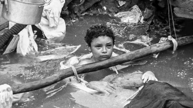 A photo released by El Espectador shows Omayra Sanchez, 12, trapped in Armero, Colombia on Nov. 15, 1985. The young girl, who was conscious nearly to the end, bore her fate with quiet dignity as emergency workers struggled to free her legs from the mangled remains of her house. They eventually gave up, deciding the best they could do was comfort her. The photo shocked the world and won a World Press Photo of the Year award.