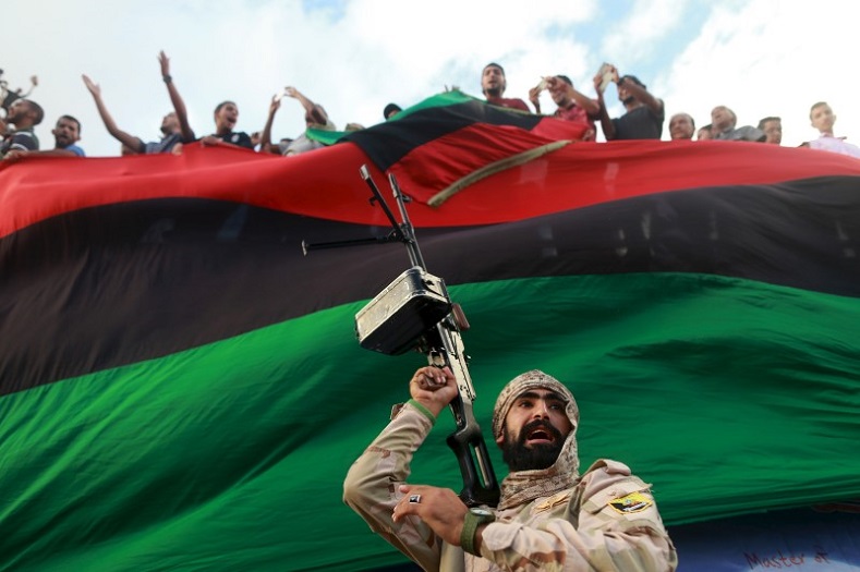 A member of the military protects a demonstration against candidates for a national unity government proposed by U.N. envoy for Libya Bernardino Leon.
