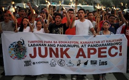 Activists hold up torches while marching to the U.S Embassy during a rally ahead of the Asia-Pacific Economic Cooperation summit in Manila.