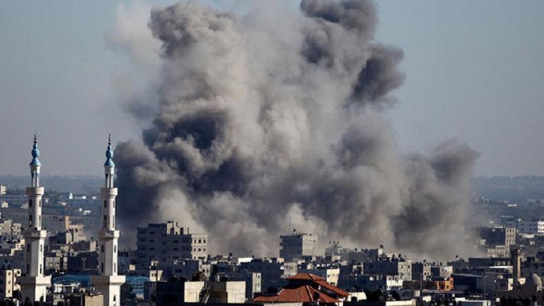 Smoke rises from buildings following an Israeli air strike in Gaza City July 11, 2014.