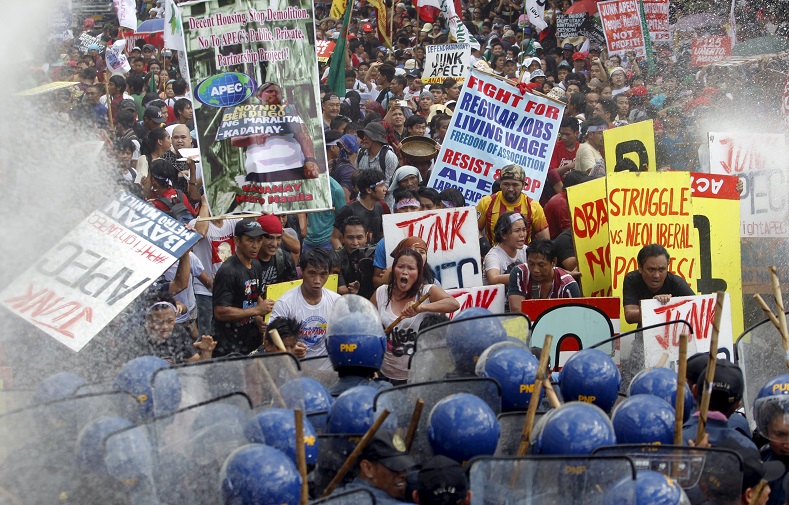 “Protesters shout as they march toward the APEC Summit in Manila on Nov. 19, 2015.”