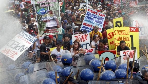 “Protesters shout as they march toward the APEC Summit in Manila on Nov. 19, 2015.” 
