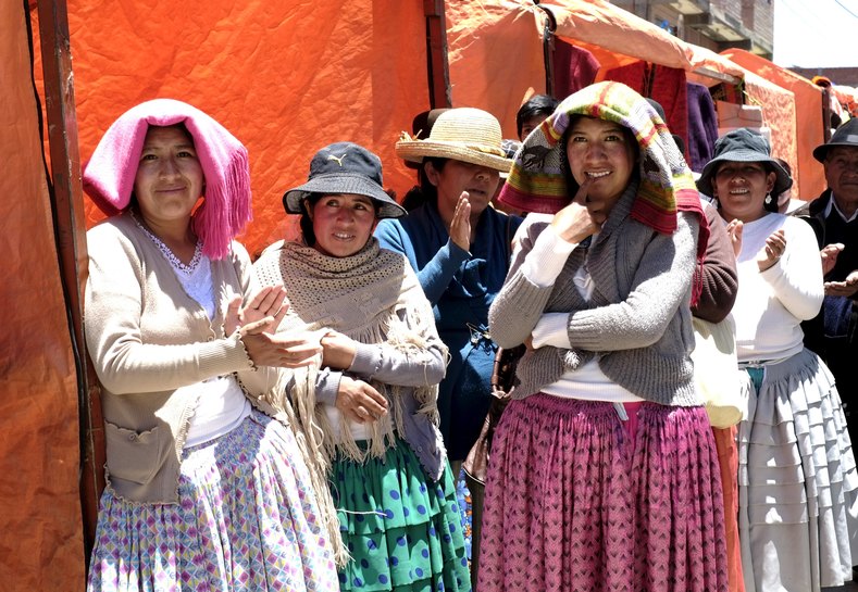Aymara women stand at a fair held on the side of the Cholita fashion show at Villa Esperanza.