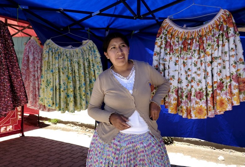An artisan stands at the fair of the Cholita fashion show at Villa Esperanza.