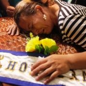 Teresa Munoz mourns over the coffin of her daughter Maria Jose Alvarado during a wake for Maria Jose and her sister Sofia in Honduras Nov. 20, 2014.