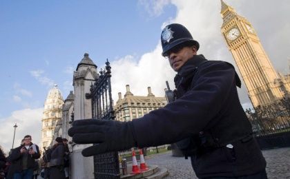 A policeman directs traffic outside the Houses of Parliament on November 25, 2015 