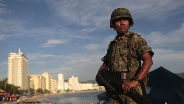A soldier stands guard in a tourist area of Acapulco, in the Mexican state of Guerrero.