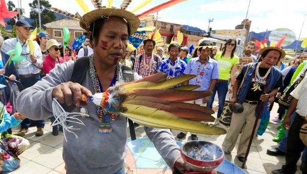An indigenous Barzano man performs a symbolic ritual in Bogota, Colombia, before a march on the global day of climate action on the eve of COP21.