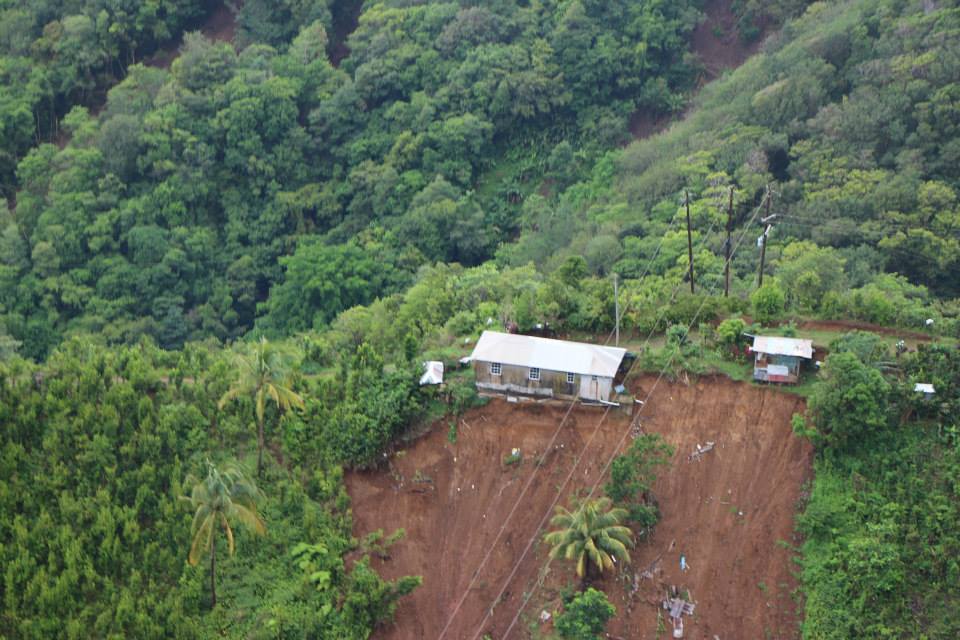 House in Dominica perched precariously after Tropical Storm Erika. Caribbean Leaders say climate change is already wreaking havoc on small islands.