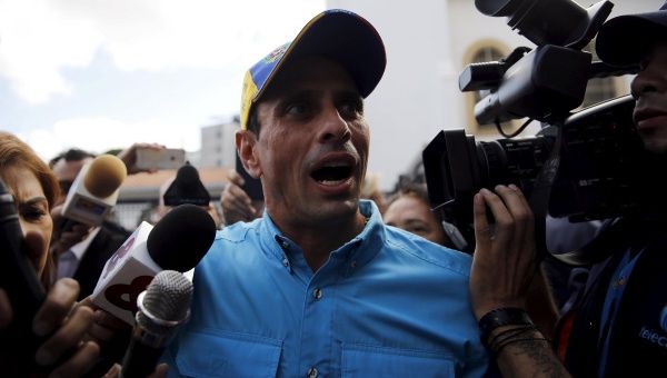 Venezuelan opposition leader Henrique Capriles talks to the media after casting his vote at a polling station during a legislative election, in Caracas.