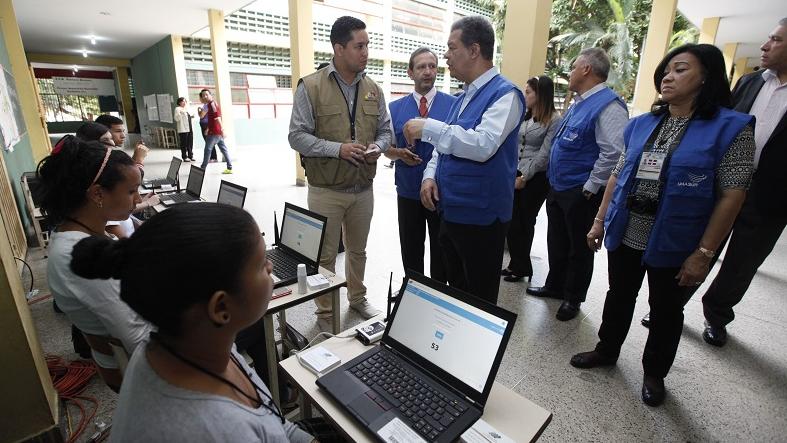 An electoral accompaniment team from the Union of South American Nations visits a voting center in Caracas, Venezuela, Dec. 6, 2015.