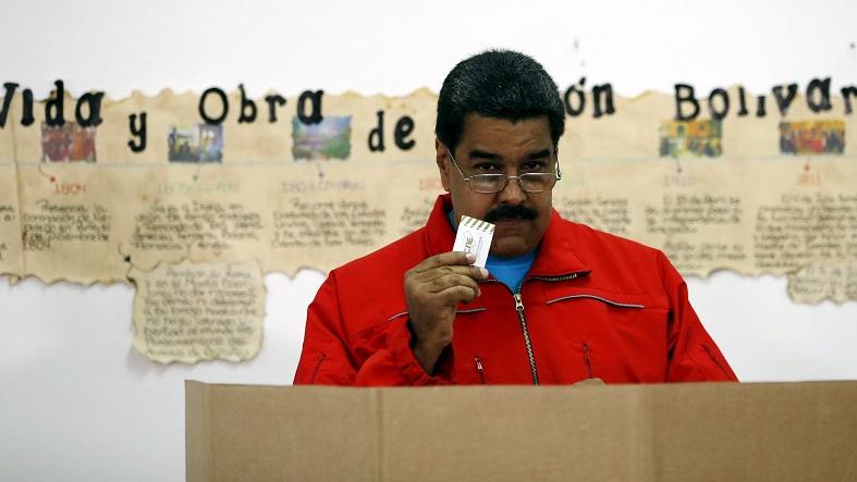 Venezuela's President Nicolas Maduro shows his ballot before casting his vote at a polling station during a legislative election, in Caracas Dec. 6, 2015.