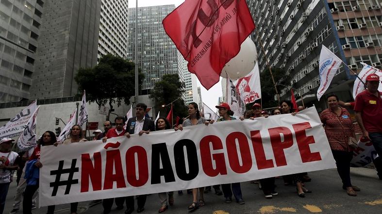 People with a banner that reads “No to the coup” attend a protest against the impeachment proceedings against President Dilma Rousseff, Brazil Dec. 8, 2015.