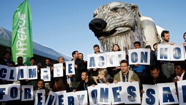 Greenpeace campaigners rally to demand a just climate deal in Paris.