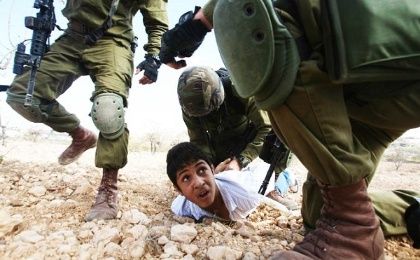 A Palestinian youth is arrested by Israeli soldiers during a protest against the Jewish settlement of Karmi Tsour on Oct. 23, 2010.