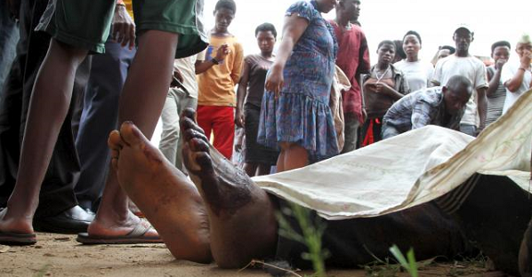 Residents look at the slain bodies of people killed at the Cibitoke district in Burundi's capital Bujumbura, Dec. 9, 2015.