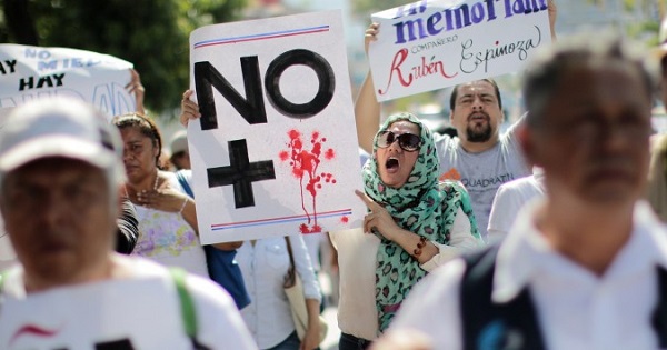 Activists protest state violence in Mexico after the murder of journalist Ruben Espinoza, activist Nadia Vera, and two other women in August 2015.