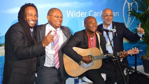 Dr. James Fletcher (2ndL) and OECS Director General Dr. Didacus Jules (R) join Caribbean artists at the Wider Caribbean Pavilion at COP21 in Paris.