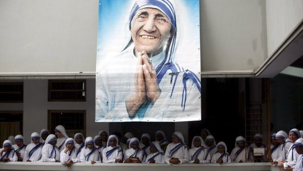Catholic nuns from the order of the Missionaries of Charity gather under a picture of Mother Teresa during the 10th anniversary of her death in Kolkata, India.
