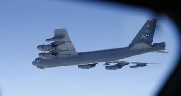 A U.S. Air Force B-52 is seen through the window of another during a training mission in the United Kingdom's airspace, Jun.17, 2014.