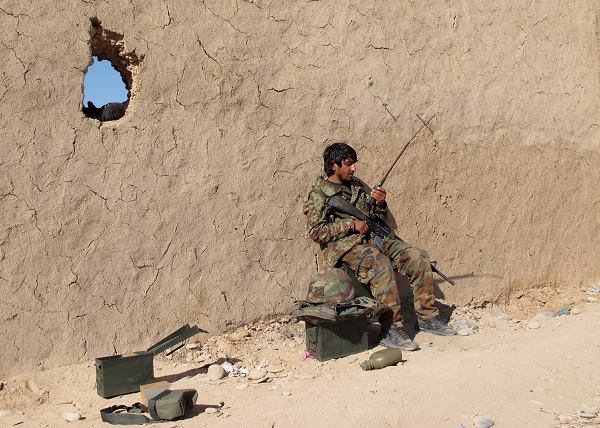 An Afghan National Army soldier speaks on a radio at an outpost in Helmand province.