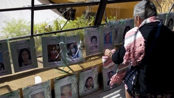 A mother places a picture of her disappeared son at the ninth caravan of women that ended on Saturday in Chiapas, Mexico.