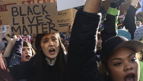 Black Lives Matter protesters shout during a protest in Seattle.